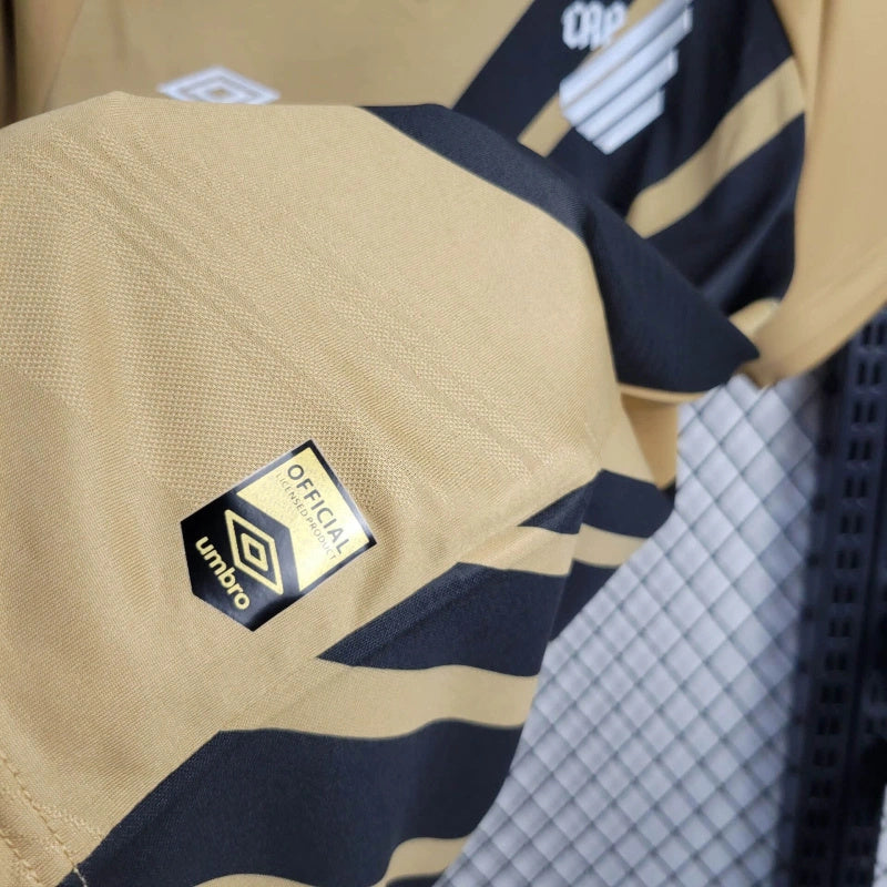 camisa-athletico paranaense-away-ii-2-dourada-umbro-24-25-neymar-messi-cr7-futebol 